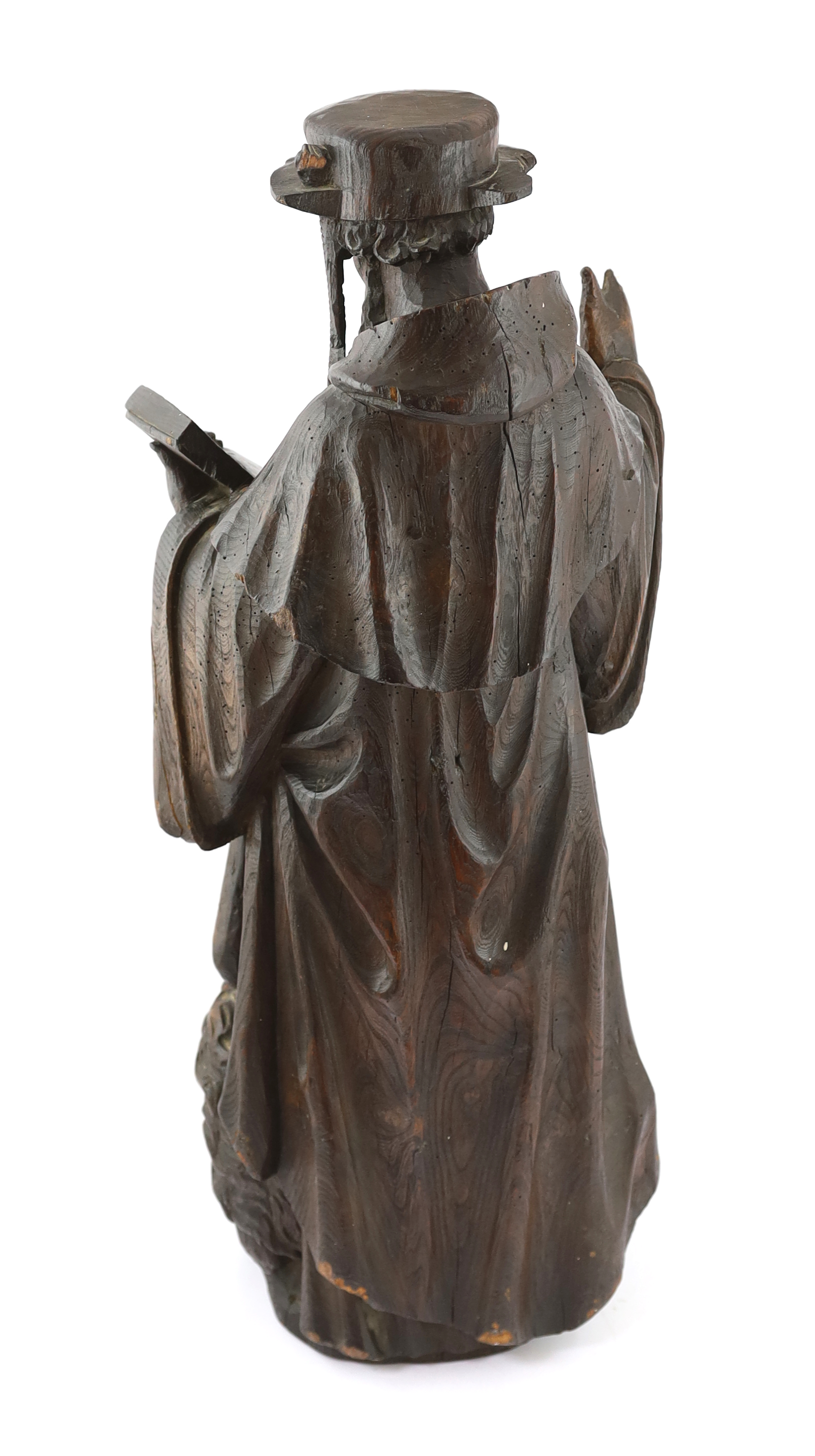 A 19th century carved pine figure of St. Jerome reading from the bible 32cm wide, 79cm high